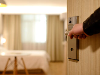 Person opening hotel room door